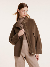 a lady in brown wool jacket with beige knitted pants